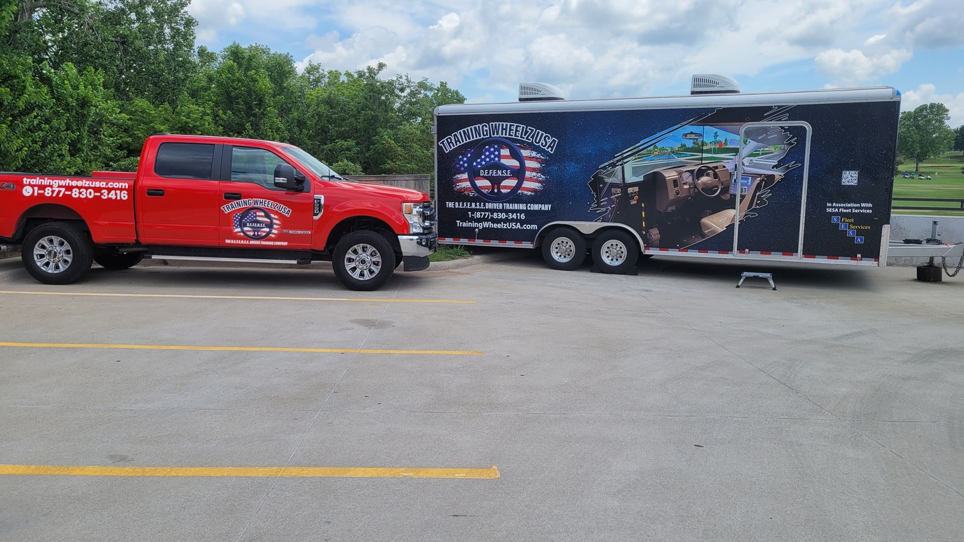 Training Wheelz USA trailer beside a support vehicle