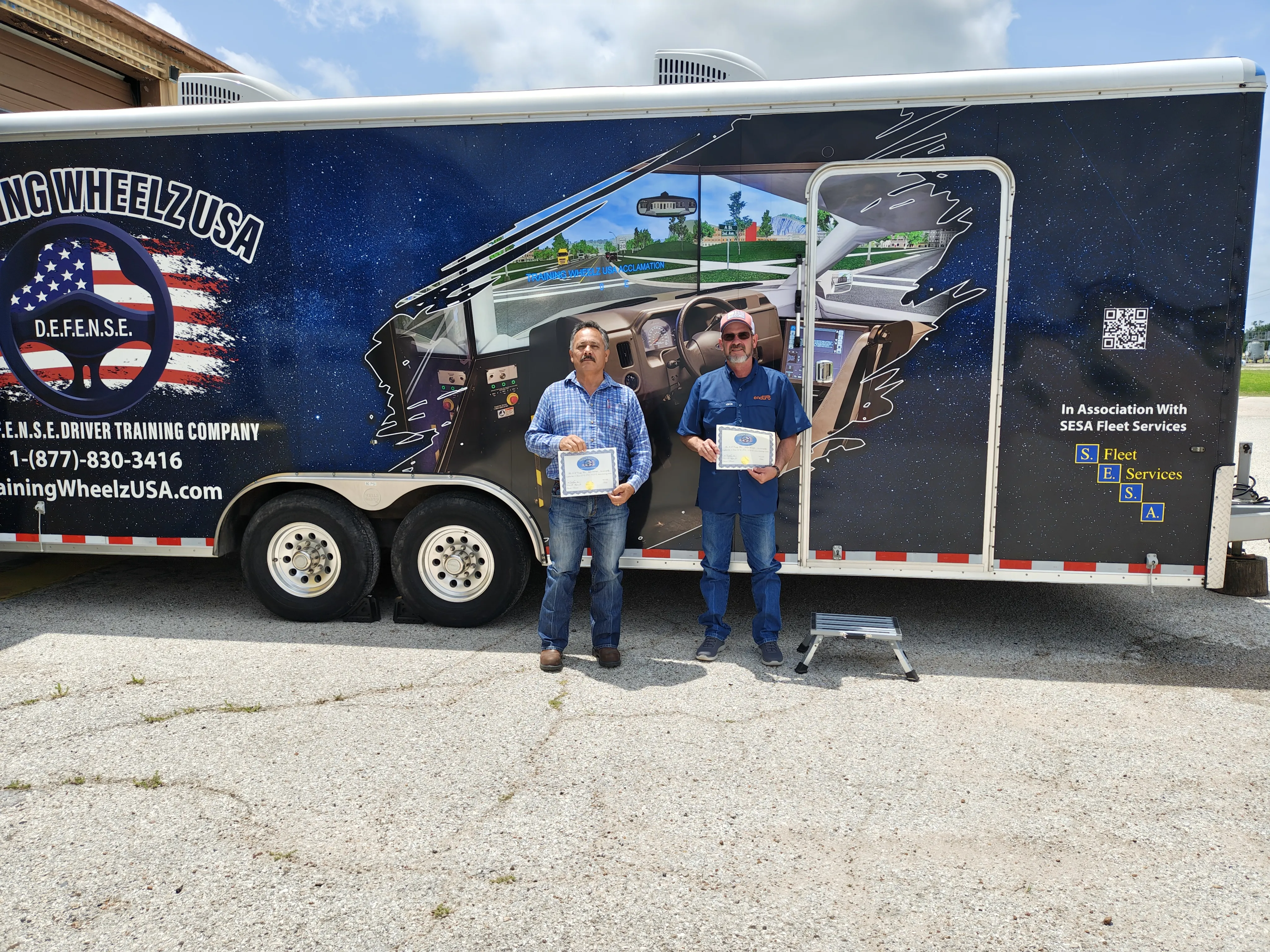 Training Wheelz USA team beside the mobile training trailer